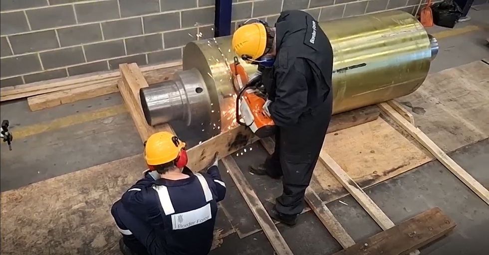 Border force workers using tools to access the drugs