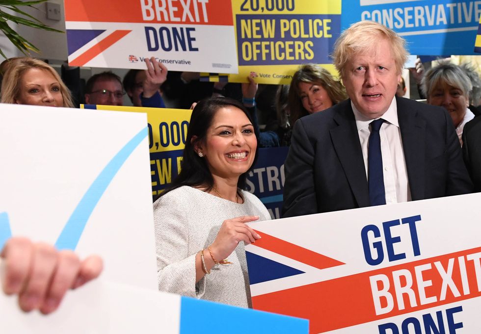 Boris Johnson and Priti Patel during a members rally held
