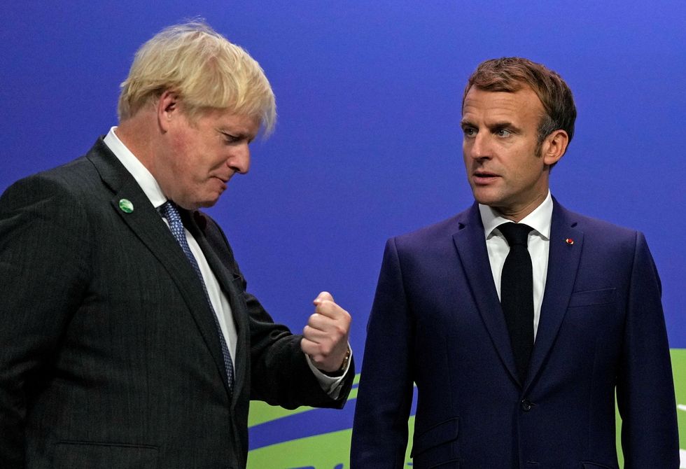 Boris Johnson greets France's President Emmanuel Macron during arrivals at the UN Climate Change Conference (COP26) in Glasgow