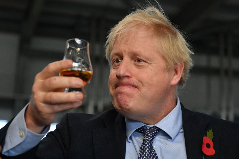 Boris Johnson holding a drink