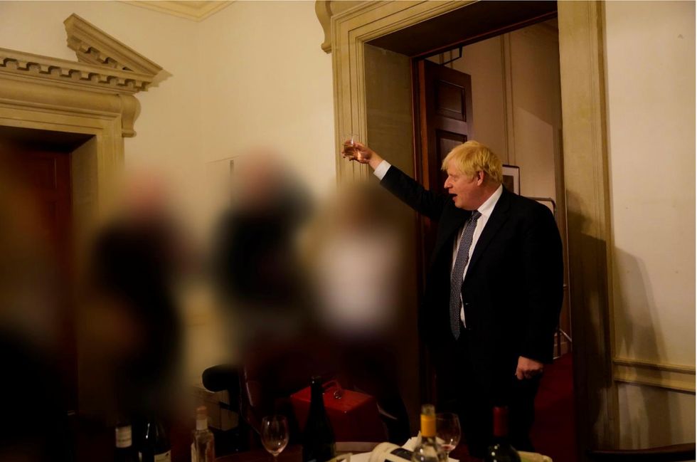 Boris Johnson raises a glass at a Downing Street party.