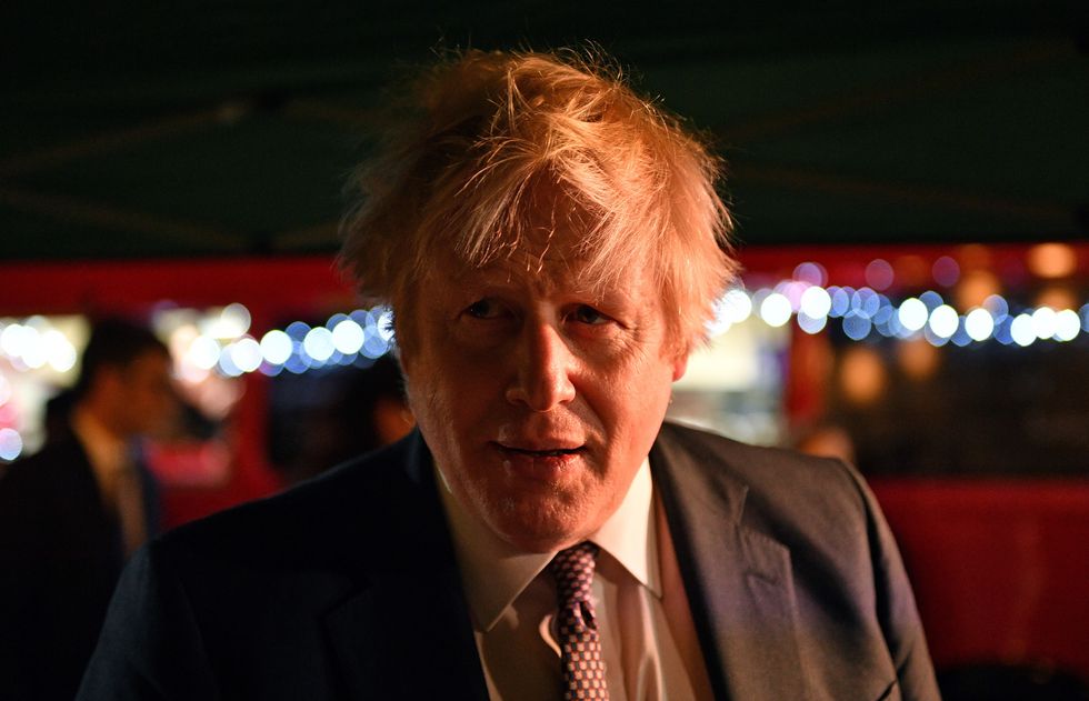Boris Johnson reacts as he talks to stall holders as he visits a UK Food and Drinks market which has been set up in Downing Street, London