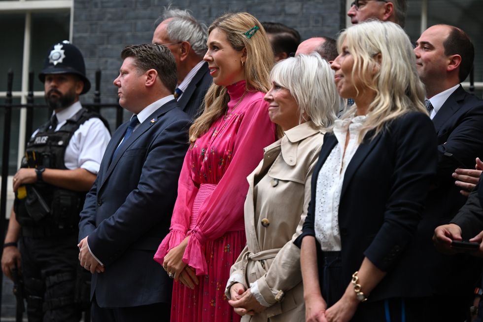 Boris Johnson's wife Carrie (centre) stands with Nadine Dorris (right) on Downing Street