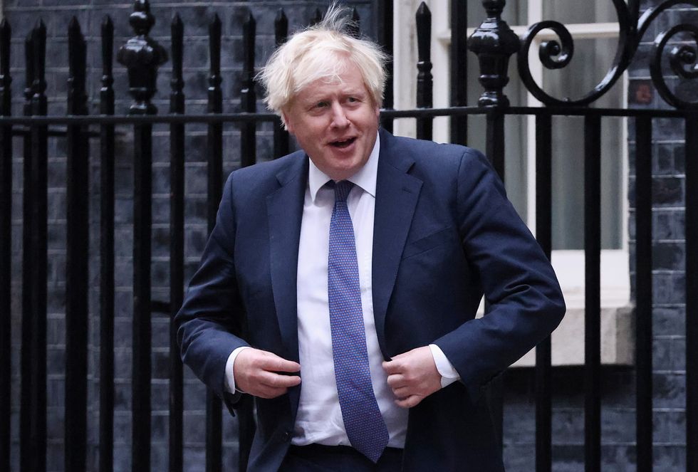 Boris Johnson walks outside Downing Street