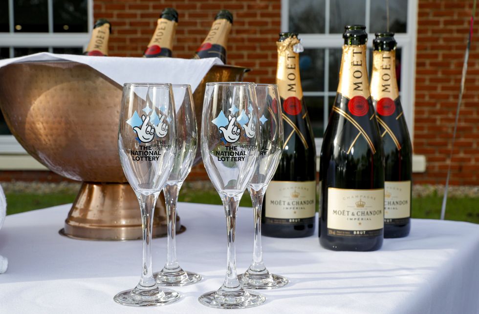 Bottles of Moet & Chandon champagne with The National Lottery branded champagne flutes