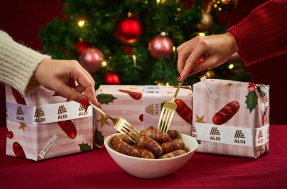 Bow of pigs in blankets and Aldi's lickable Pigs in Blankets paper wrapping paper
