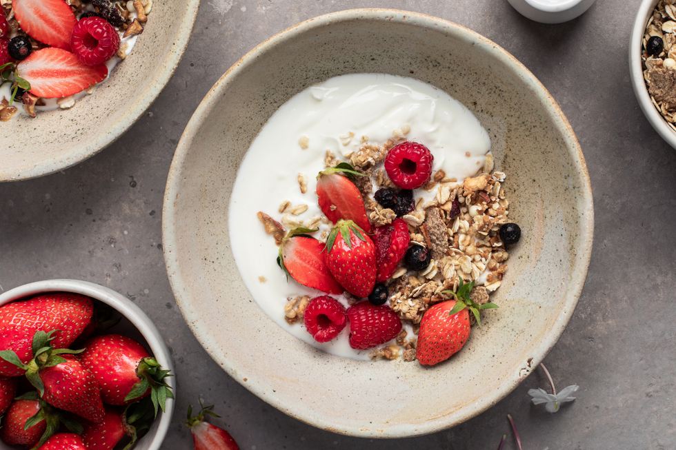 Bowl with yoghurt, strawberries, raspberries, blackcurrants and oats