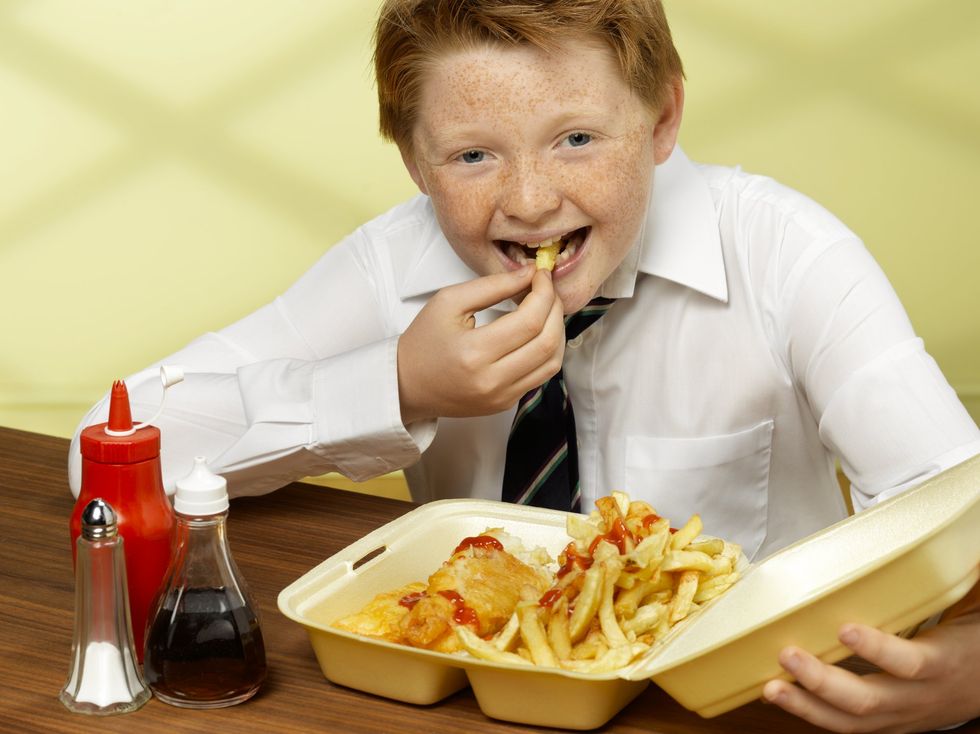 Boy eating fish and chips