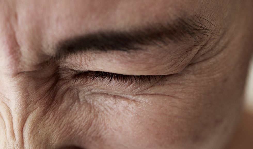 Boy squinting out of pain