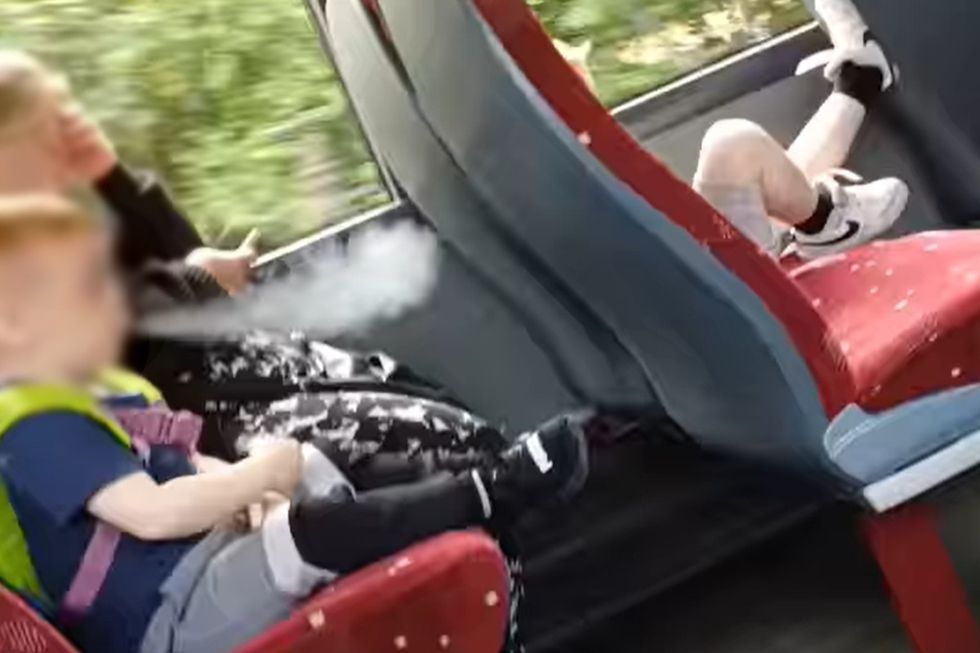 Boy vaping on bus