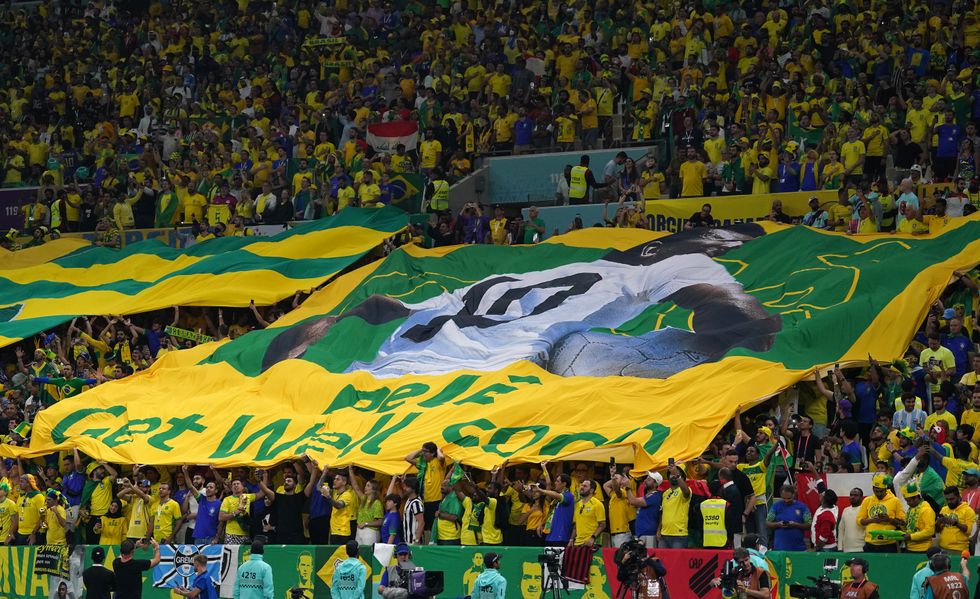 Brazil fans hold a banner saying Pele Get Well Soon during the FIFA World Cup Group G match at the Lusail Stadium in Lusail, Qatar. Picture date: Friday December 2, 2022.