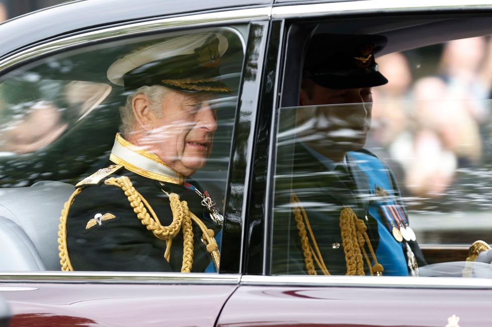 Britain's King Charles and Britain's William, Prince of Wales are seen travelling in a car on The Mall, on the day of the state funeral and burial of Britain's Queen Elizabeth, in London, Britain, September 19, 2022 REUTERS/Peter Cziborra