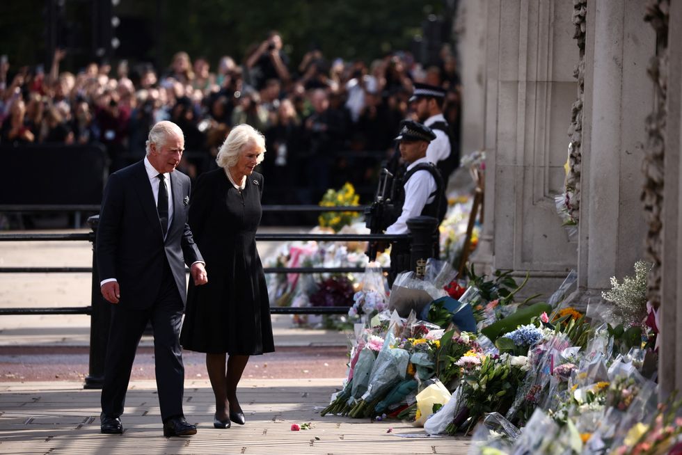 Britain's King Charles and Queen Camilla walk outside Buckingham Palace, following the passing of Britain's Queen Elizabeth, in London, Britain, September 9, 2022. REUTERS/Henry Nicholls