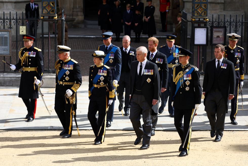 Britain's King Charles, Anne, Princess Royal, Prince Andrew, Prince Edward, William, Prince of Wales, Prince Harry, Duke of Sussex, and Peter Phillips walk after a service at Westminster Abbey on the day of the state funeral and burial of Britain's Queen Elizabeth, as Britain's Queen Camilla, Prince George, Princess Charlotte and Catherine, Princess of Wales, stand in the distance, in London, Britain, September 19, 2022.  REUTERS/Hannah McKay/Pool