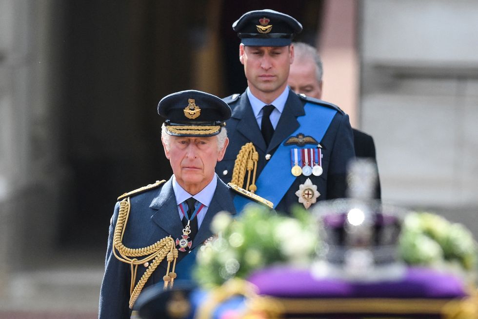 Britain's King Charles III and Britain's Prince William, Prince of Wales walk behind the coffin of Queen Elizabeth II, adorned with a Royal Standard and the Imperial State Crown and pulled by a Gun Carriage of The King's Troop Royal Horse Artillery, during a procession from Buckingham Palace to the Palace of Westminster, in London on September 14, 2022. DANIEL LEAL/Pool via REUTERS