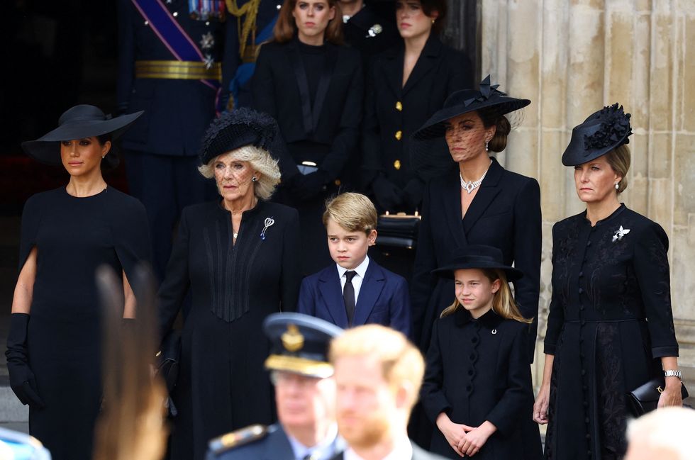 Britain's Meghan, Duchess of Sussex, Queen Camilla, Prince George, Princess Charlotte, Catherine, Princess of Wales, and Sophie, Countess of Wessex stand outside Westminster Abbey after a service on the day of the state funeral and burial of Britain's Queen Elizabeth, in London, Britain, September 19, 2022.  REUTERS/Hannah McKay/Pool