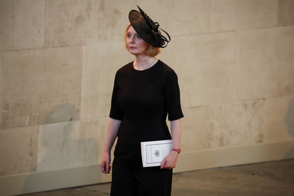 Britain's Prime Minister Liz Truss walks as procession with the coffin of Britain's Queen Elizabeth arrives at Westminster Hall from Buckingham Palace for her lying in state, in London, Britain, September 14, 2022.  REUTERS/Phil Noble/Pool