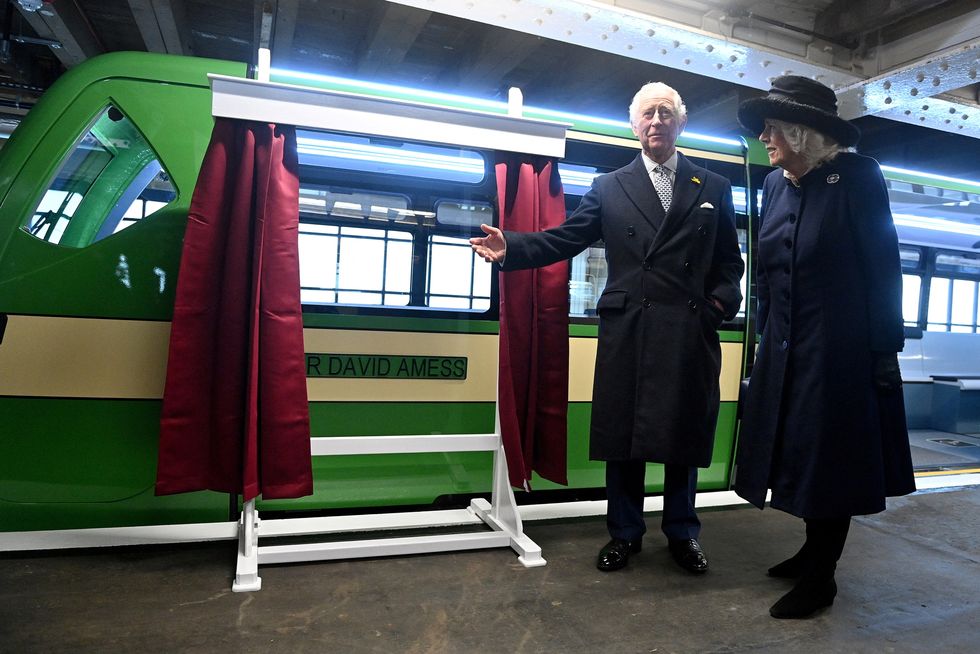 Britain's Prince Charles and his wife Britain's Camilla, Duchess of Cornwall, unveil a new eco-friendly Pier Train, named after murdered MP David Amess, during their visit to the Pier in Southend-on-Sea, Britain March 1, 2022. Justin Tallis/Pool via REUTERS