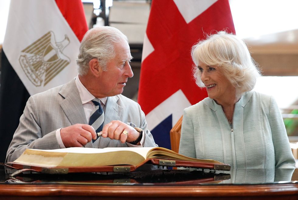 Britain's Prince Charles prepares to sign a visitors book next to Camilla, Duchess of Cornwall at the Bibliotheca Alexandrina, in Alexandria, Egypt