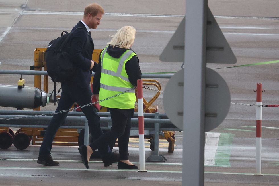 Britain's Prince Harry boards a plane at Aberdeen International Airport, following the passing of Britain's Queen Elizabeth, in Aberdeen, Britain, September 9, 2022. REUTERS/Phil Noble