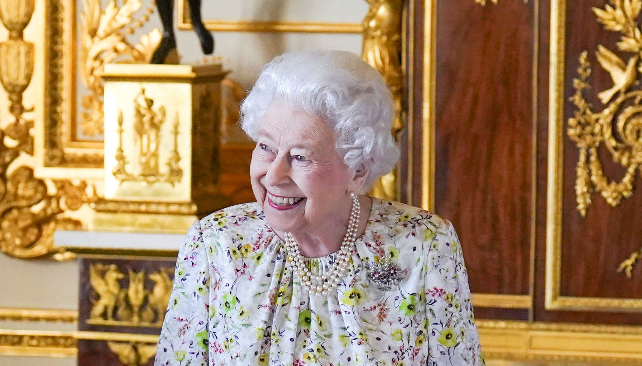 Britain's Queen Elizabeth smiles as she arrives to view a display of artefacts from British craftwork company, Halcyon Days to commemorate the company's 70th anniversary in the White Drawing Room at Windsor Castle.