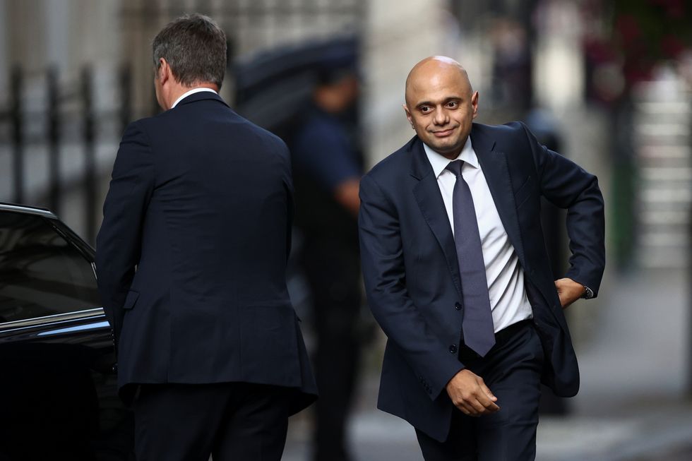 Britain's Secretary of State for Health and Social Care Sajid Javid walks outside Downing Street in London