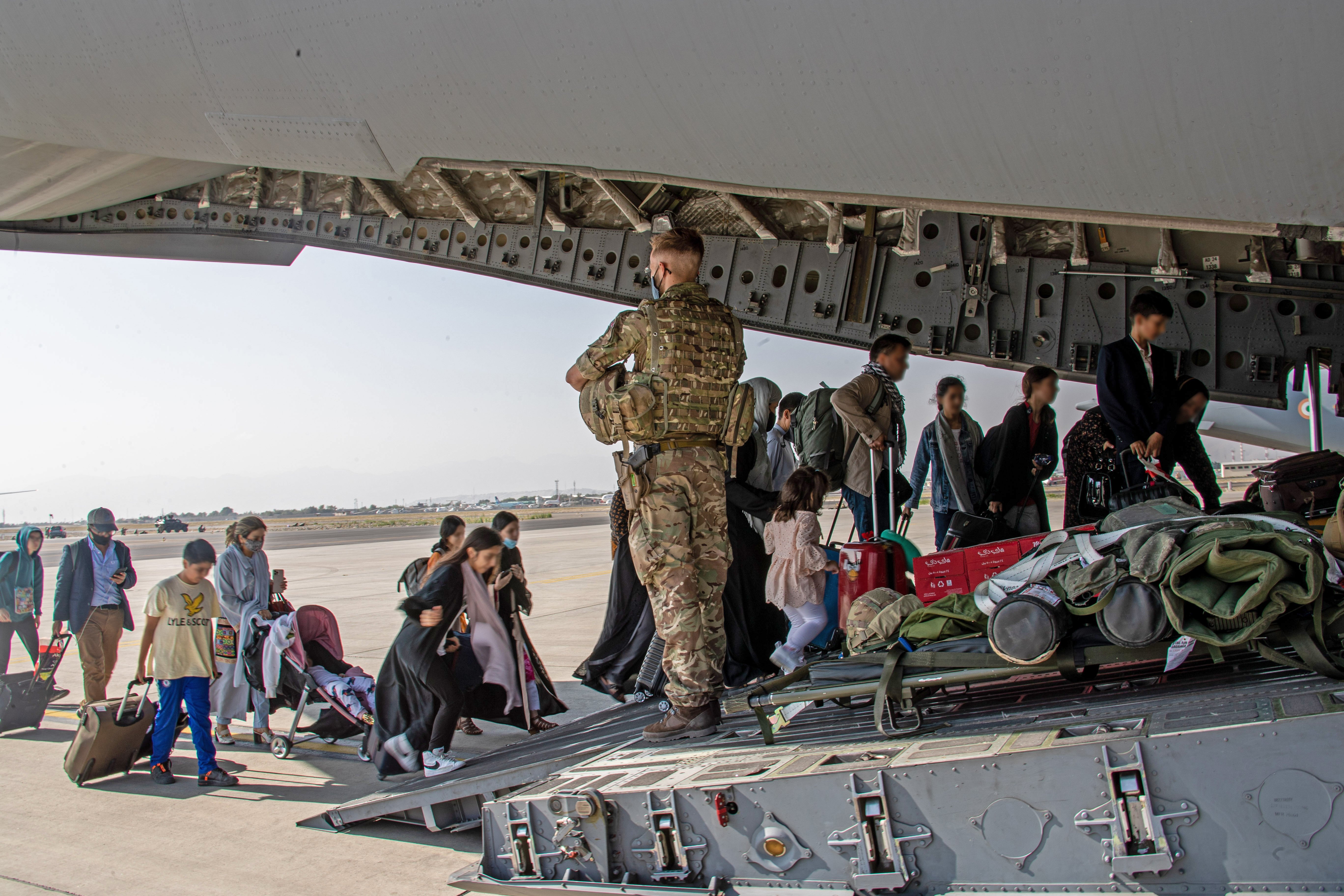 British citizens and dual nationals residing in Afghanistan getting on a RAF plane before being relocated to the UK.