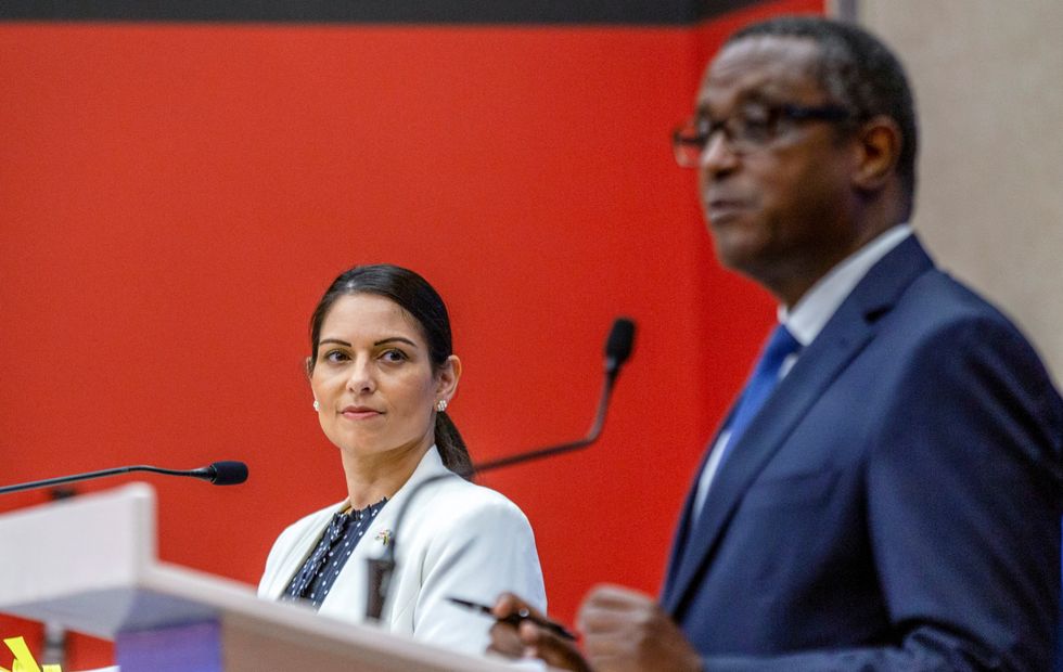 British Home Secretary Priti Patel looks on as Rwandan Foreign Minister Vincent Biruta, addresses a joint news conference, after signing the partnership agreement in Kigali, Rwanda.