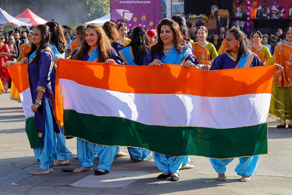 British Indians holding an Indian flag