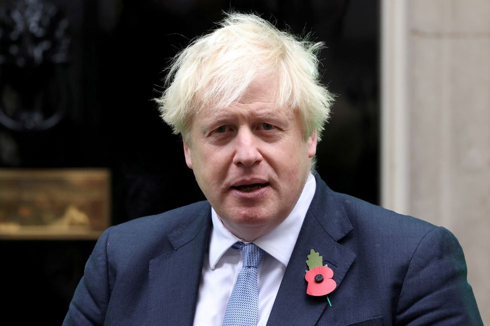 British Prime Minister Boris Johnson meets with fundraisers from the Royal British Legion outside Number 10 Downing Street in London, Britain October 29, 2021. REUTERS/Tom Nicholson/File Photo