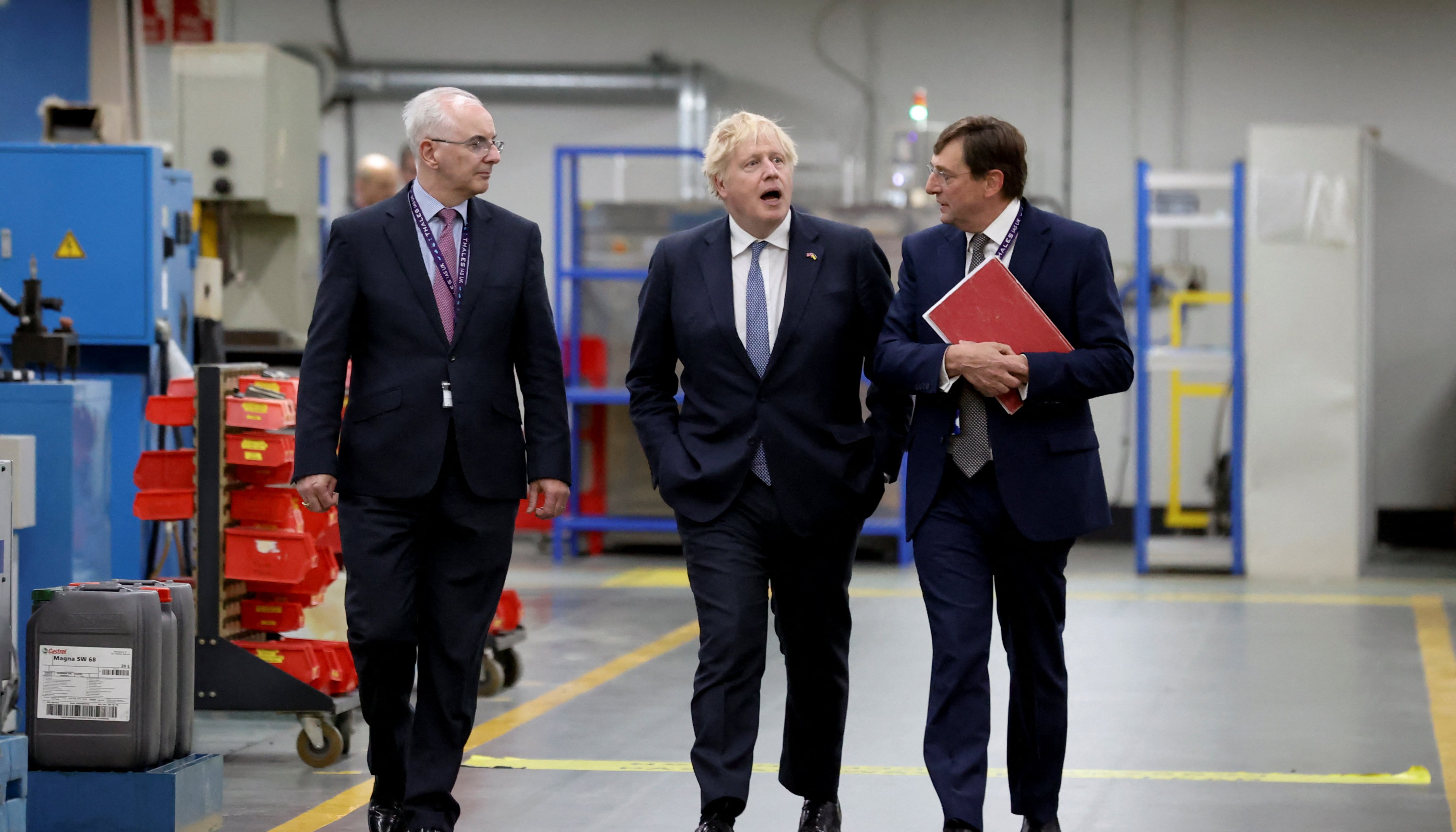 British Prime Minister Boris Johnson walks on the factory floor with Thales UK Chief Executive Officer (CEO) Alex Cresswell and Thales Belfast Managing Director Philip McBride as he visits Thales weapons manufacturer during a visit to Northern Ireland for talks with Stormont parties, in Belfast.