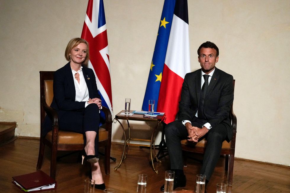 British Prime Minister Liz Truss, left, poses with France's President Emmanuel Macron during a meeting on the sidelines of the European Political Community meeting at Prague Castle in Prague, Czech Republic, Thursday, Oct 6, 2022. Leaders from around 44 countries are gathering Thursday to launch a %22European Political Community%22 aimed at boosting security and economic prosperity across the continent, with Russia the one major European power not invited. Alastair Grant/Pool via REUTERS