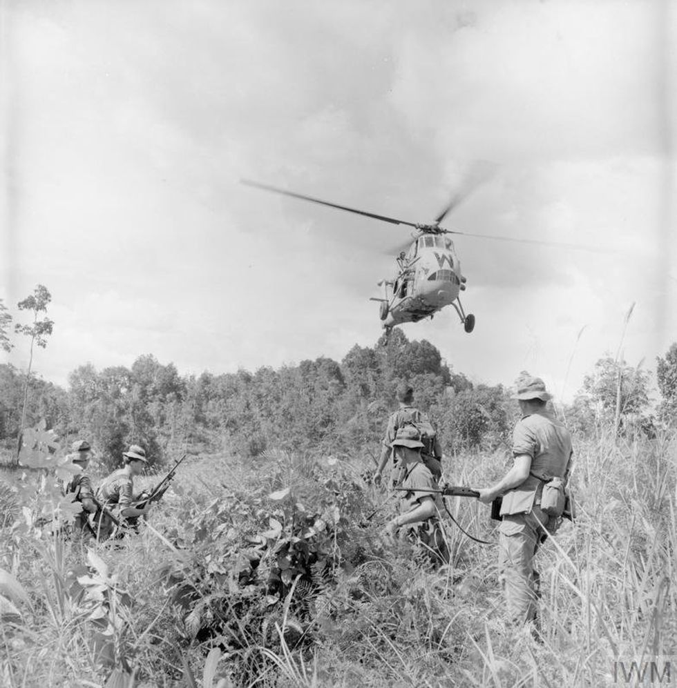 British troops wait as a Westland Wessex HAS.1 of 845 Naval Air Squadron lands to pick them up after the completion of patrol during the Indonesian Confrontation