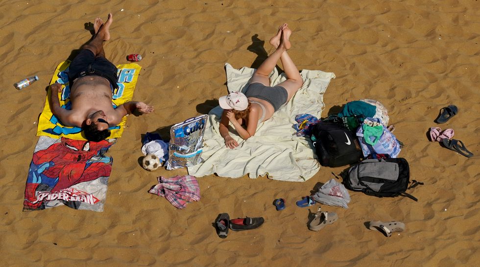 Britons relax on the beach in Broadstairs, Kent, amid a record breaking heatwave