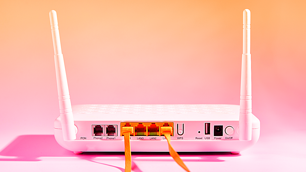 broadband router pictured with two ethernet cables plugged in