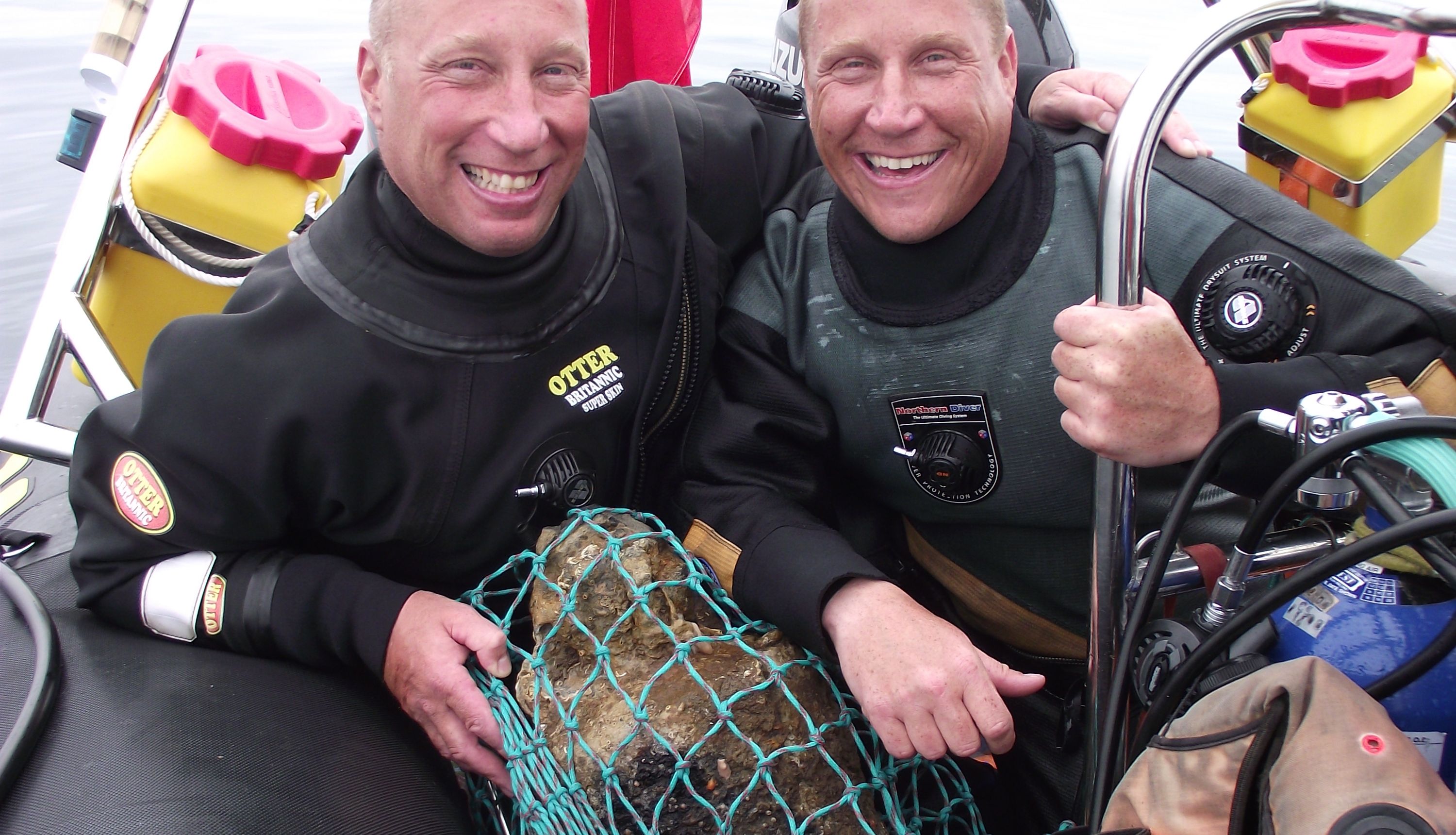Brothers Julian and Lincoln Barnwellwith with a bell from the wreck of the HMS Gloucester