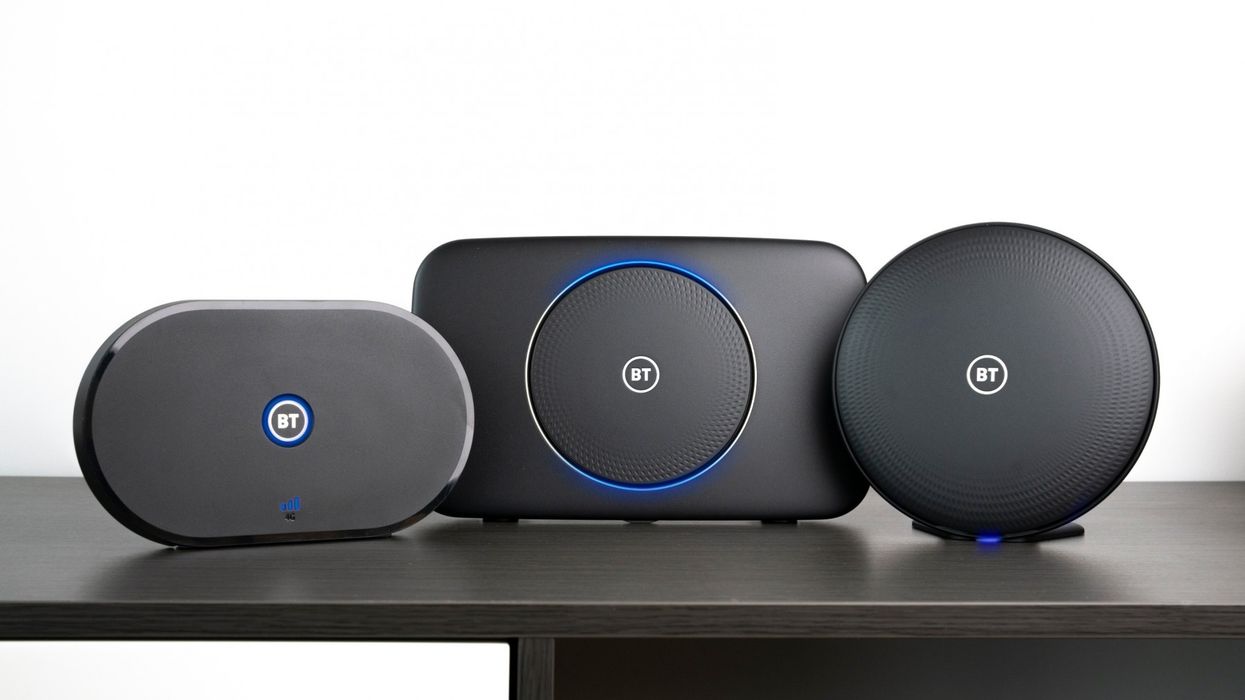 bt broadband smart hub 2 router pictured on a wooden shelf with hubs to extend wi-fi signal further into the home