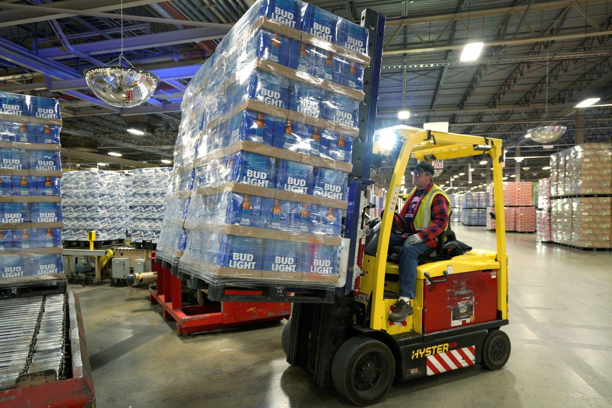 Bud Light cases being picked up by a forklift