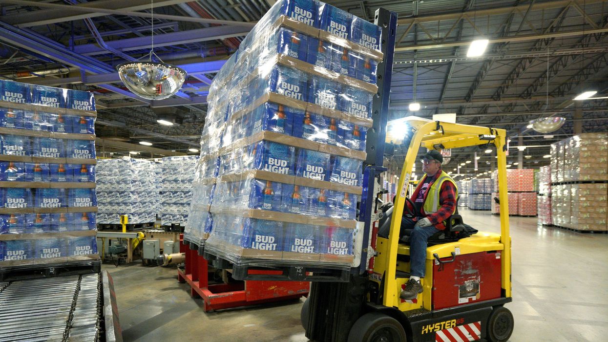 Bud Light cases being picked up by a forklift