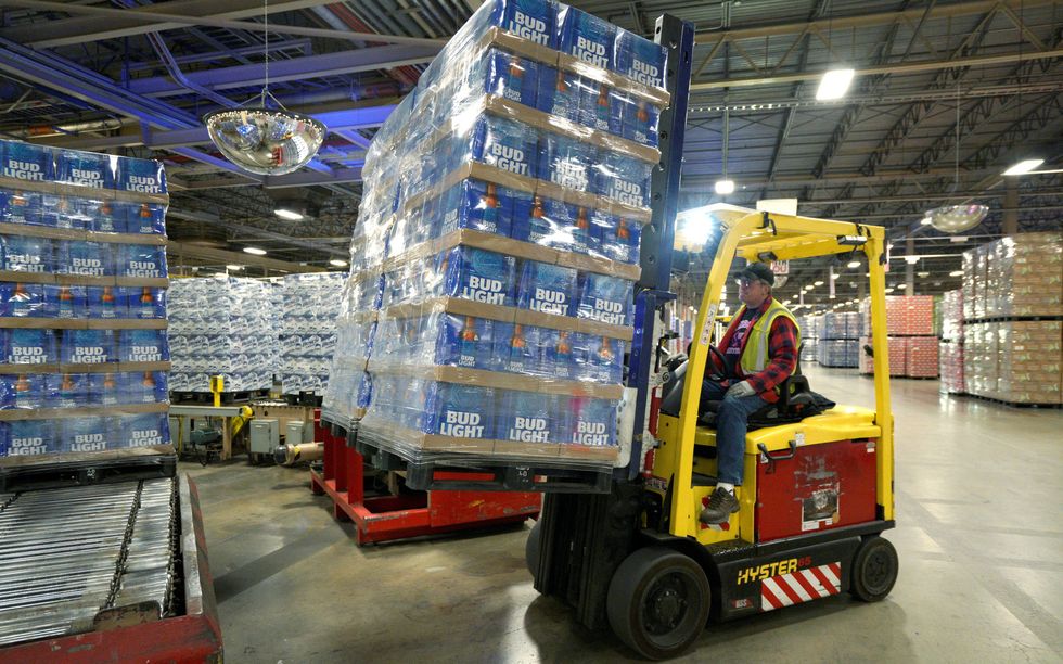 Bud Light cases being picked up by a forklift