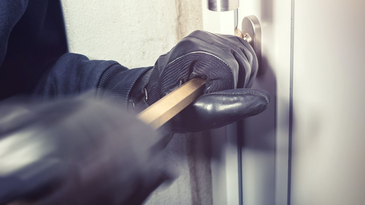 Burglar breaking into house