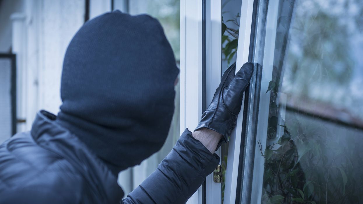 Burglar trying to open a window