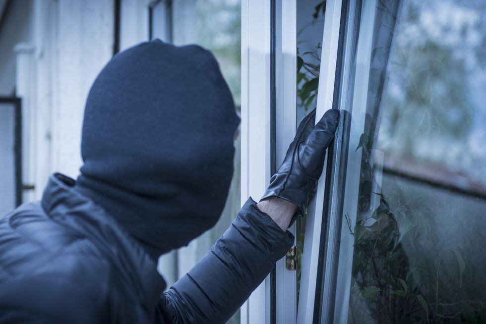 Burglar trying to open a window