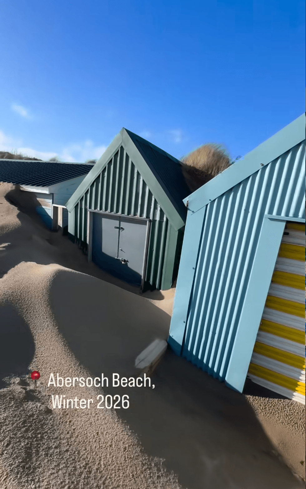 Buried beach hut on Abersoch beach