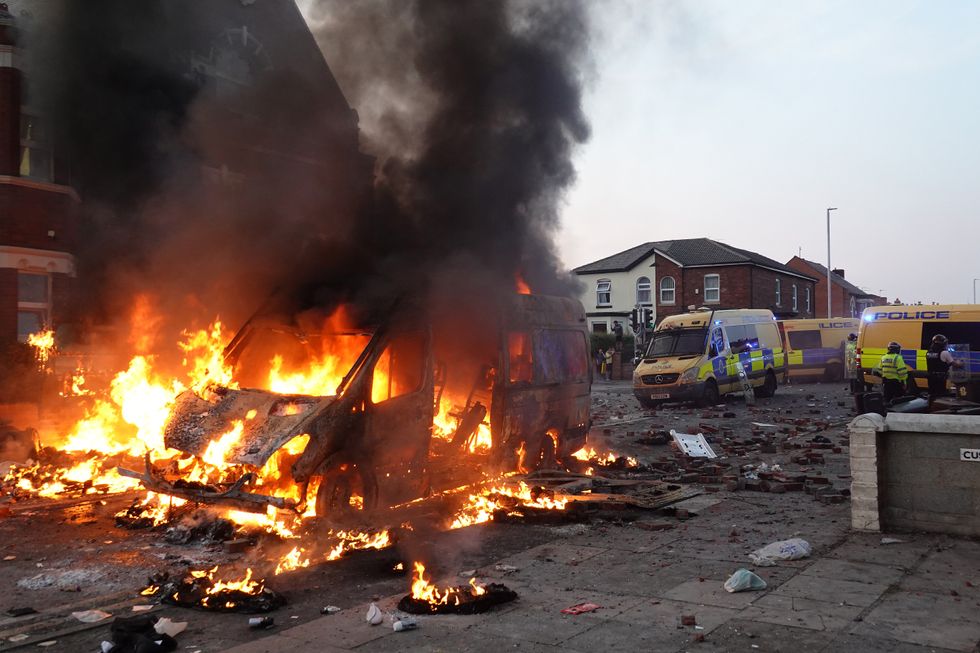 Burning police car amid Southport riots