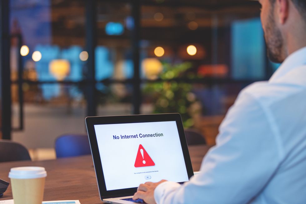 Businessman looking at an internet failure screen on a computer