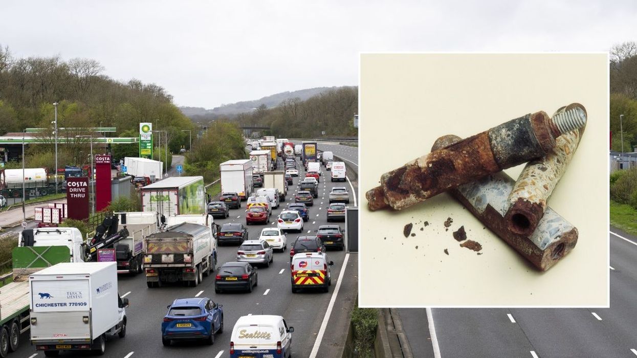 Busy motorway and a rusted, aged anchor