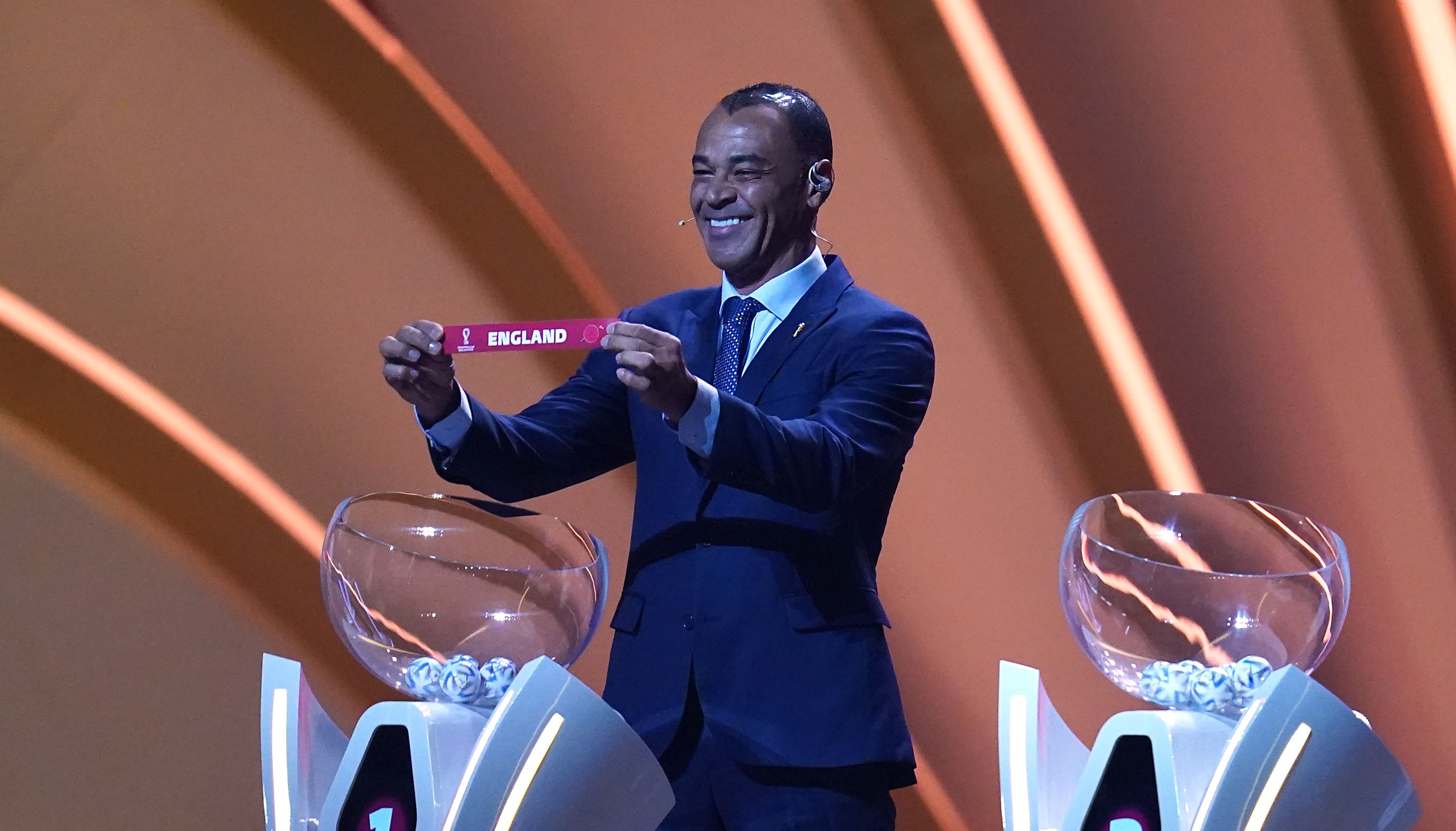 Cafu holds up England after drawing them out of Pot 1 during the FIFA World Cup Qatar 2022 Draw at the Doha Exhibition and Convention Center, Doha.