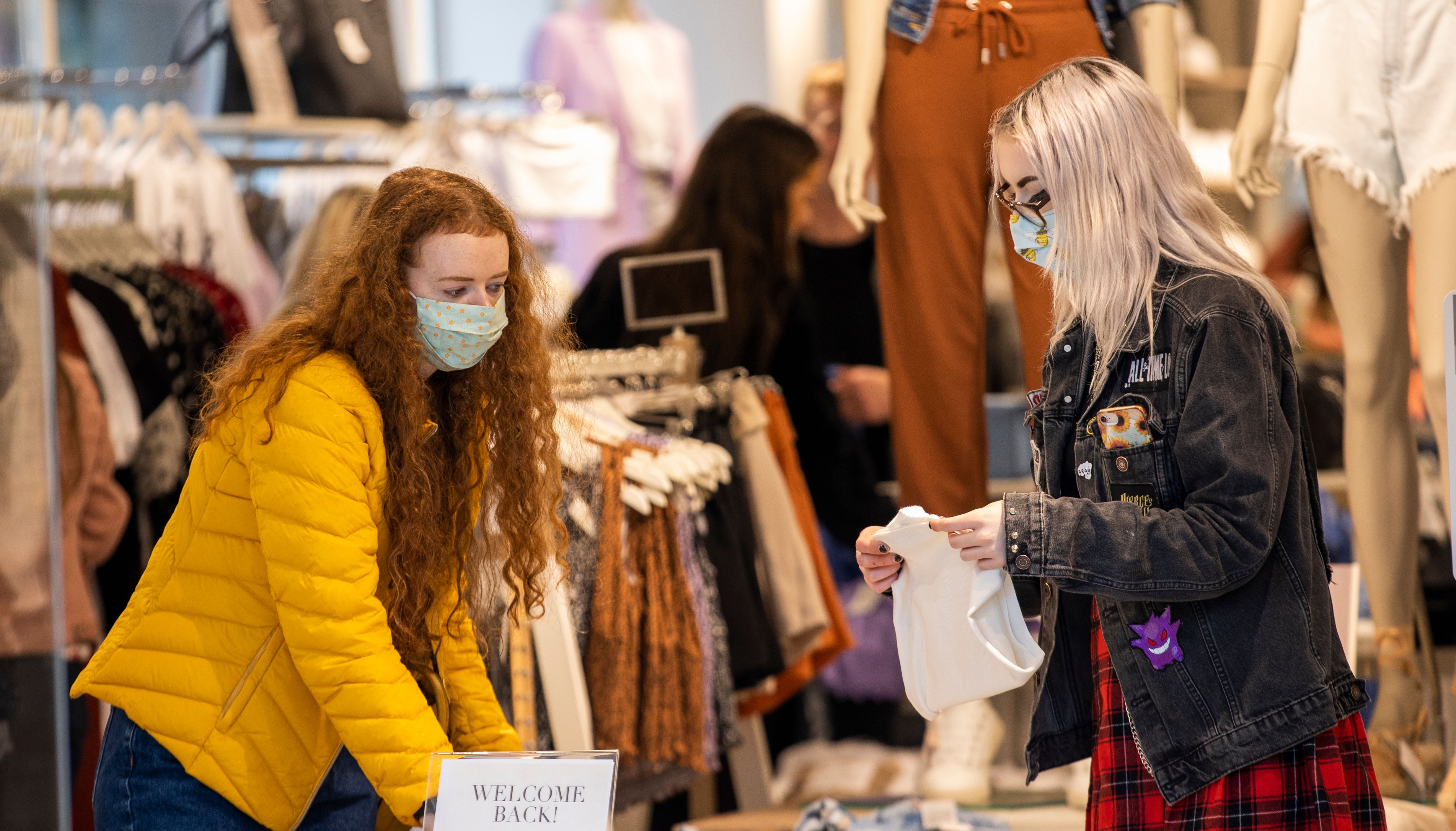 Caitlin Lunch (right) and Anna Kirkwood wearing face masks as they browse in Stradivarius in Belfast City Centres.