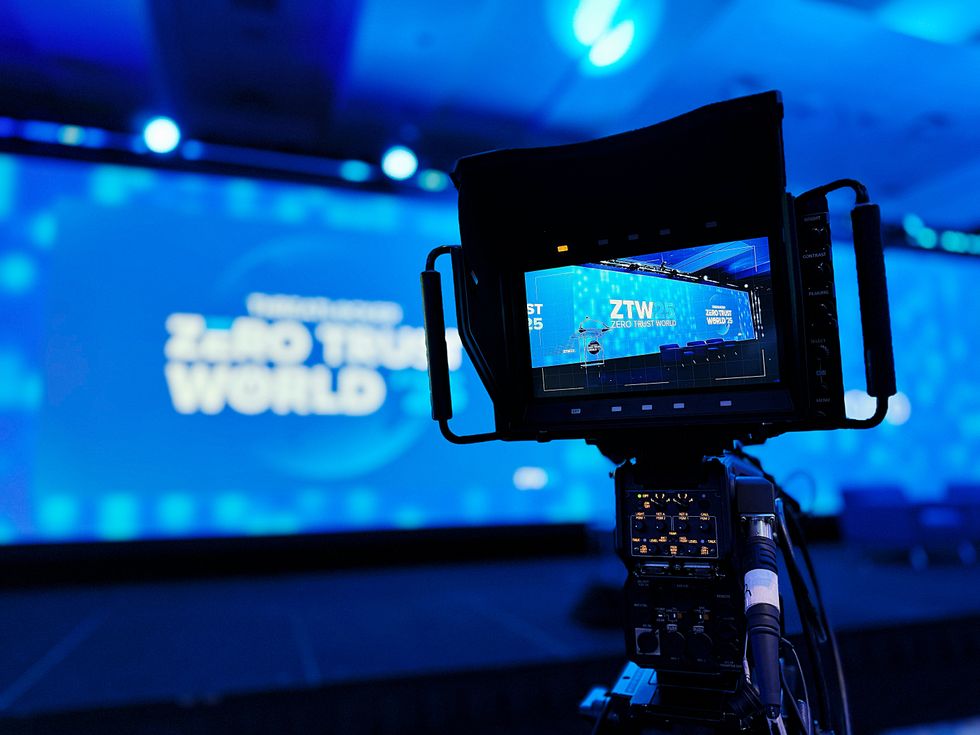 camera pointed at the zero trust sign on-stage at the threatlocker conference